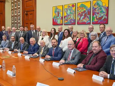 group photo at Queens Park- seated at board table