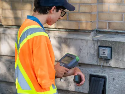 Water meter reader student reading a water meter. 