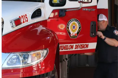 firefighter opening firetruck door