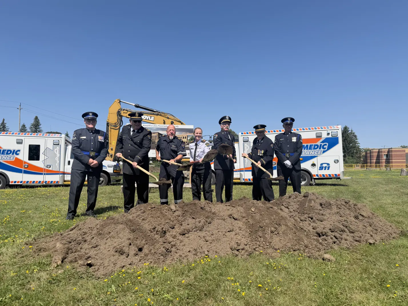 Paramedic HQ groundbreaking ceremony attendees posing with shovels