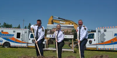 Paramedic chiefs posing with shovels at groundbreaking ceremony