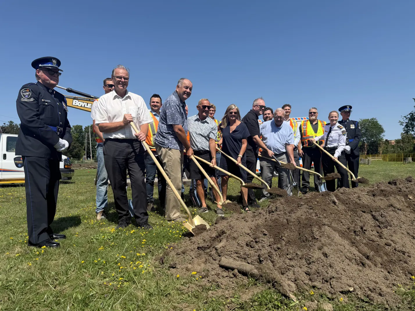 Paramedic HQ groundbreaking ceremony attendees posing with shovels