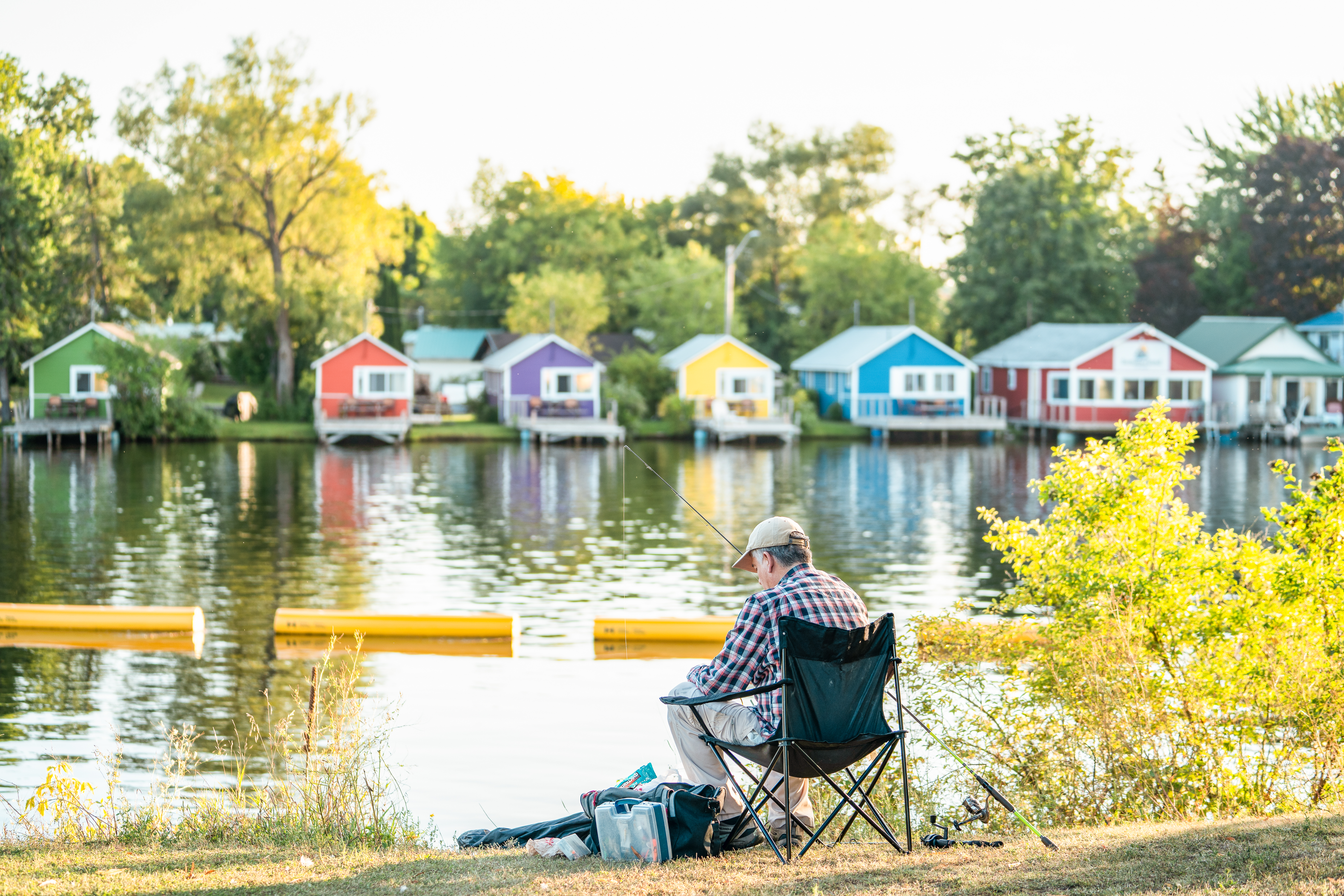 row of colourful cottages on lake