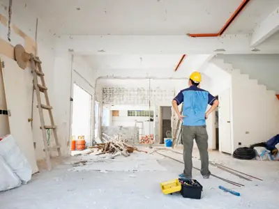 A building inspector scans the interior of a space that's under construction
